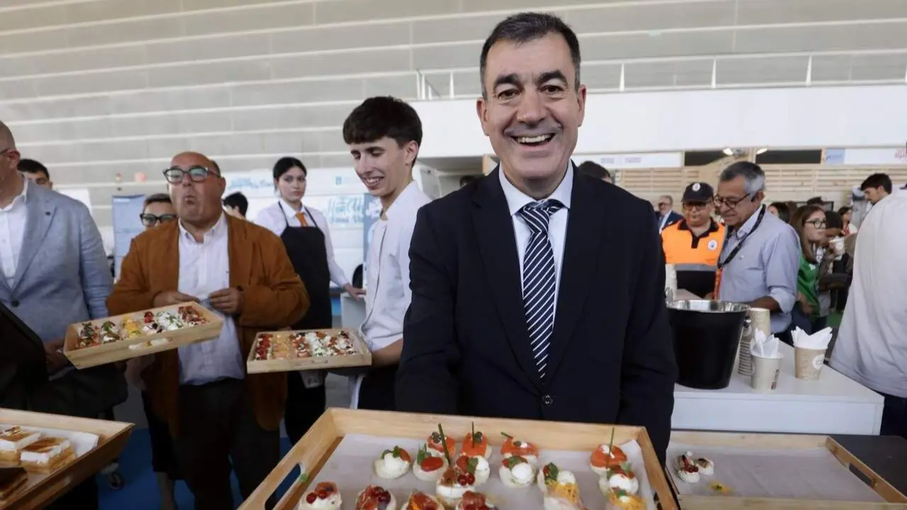 Román Rodríguez repartiendo canapés en Edugal. JAVIER CERVERA-MERCADILLO