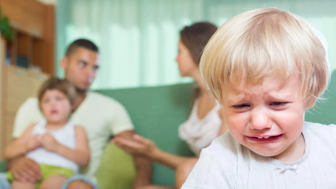 Una pareja con hijos peleándose y un niño llorando. FREEPIK